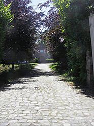 View of the front building through the cobbled avenue